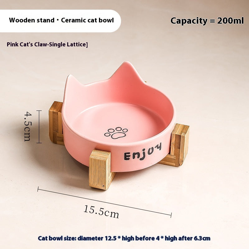 Gamelle en céramique rose sur support en bois pour les repas du chat